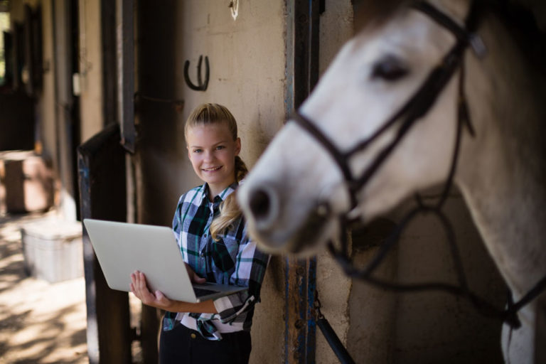 computer-horse-stall-young-girl-iStock-Wave-Break-Media-837964860-1000