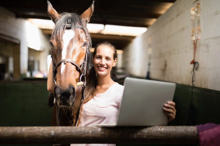 computer-woman-horse-barn-iStock-837946256-2400
