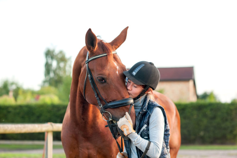 girl-kissing-horse-nose-helmet-English-iStock-Anna-Elizabeth-Photography-488313334-2400