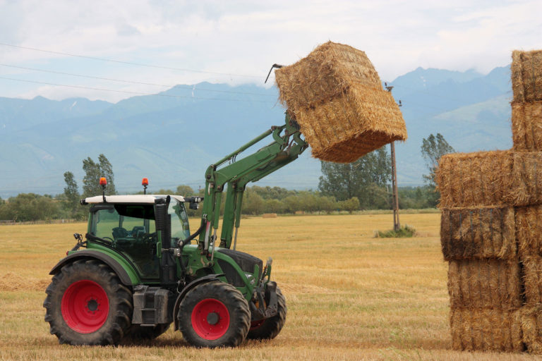 hay-large-square-bales-tractor-moving-iStock-Sal73it-1005456706-2400