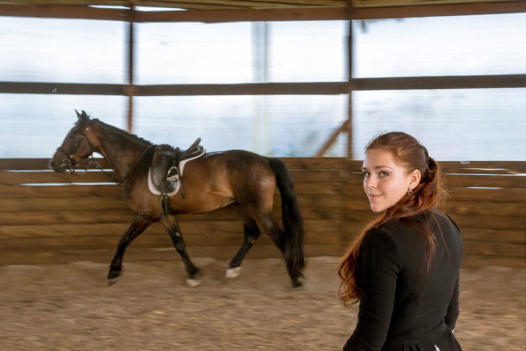 horse-lunging-woman-indoor-iStock-credit-Mordolff-187233642-2400