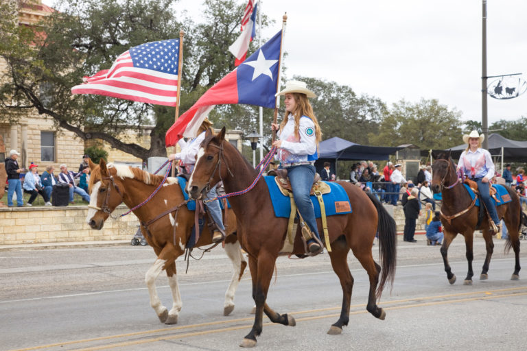 parade-western-horses-flags-iStock-credit-dhughes9-466588893-2400