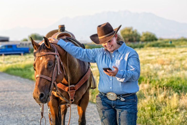 phone-cowgirl-horse-iStock-Terry-858714230-1000