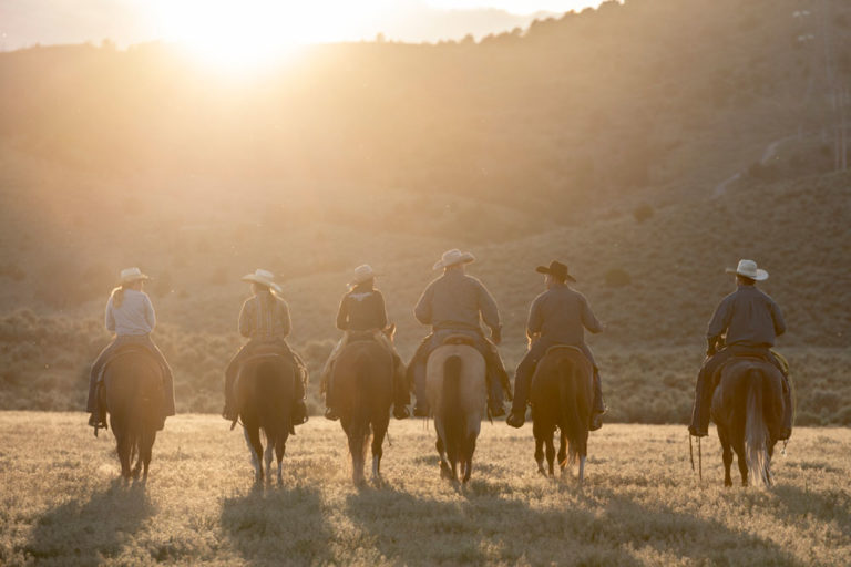 sunset-western-riders-froup-from-back-iStock-Johnny-Greig-998378532-1000