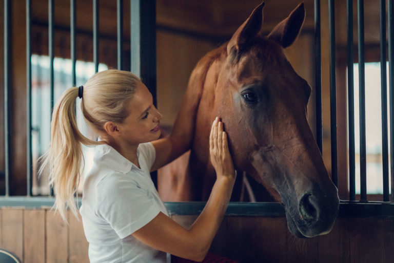 woman-horse-stall-happy-iStock-839129030-2400